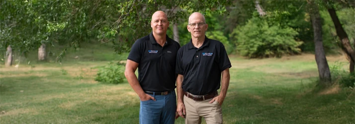 Dr. Martin Laurila and Dr. Charles Roost posing in the garden.
